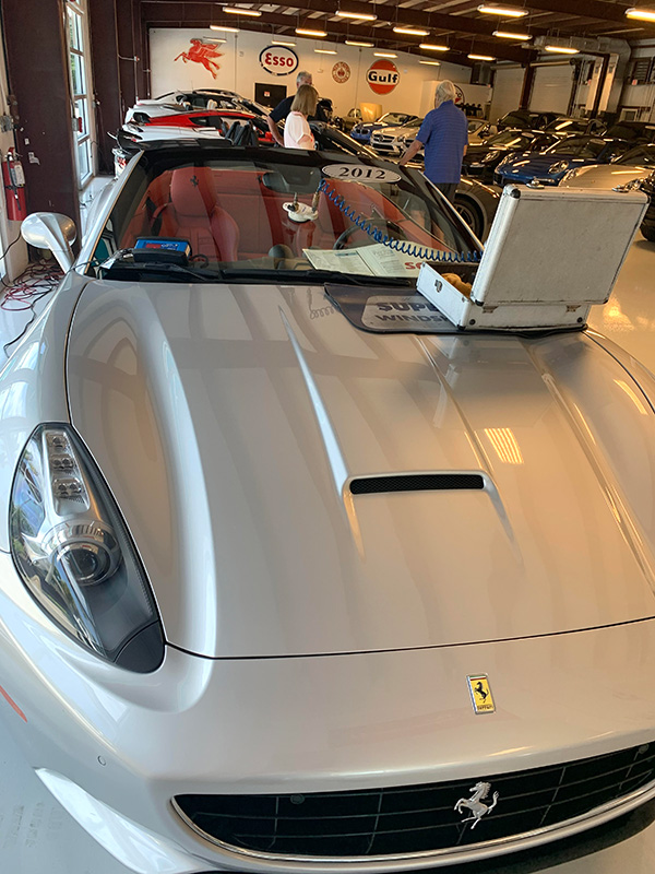 Silver Ferrari having a new windshield calibrated